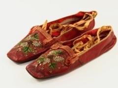 Red slippers worn by woman from Alford