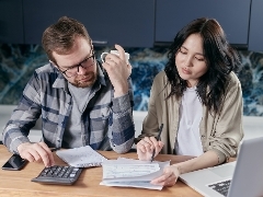 Energy Rebate two people looking at their utility bills