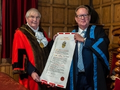 Keith Churchouse the Mayor, Cllr Dennis Booth and new Honorary Freeman, Keith Churchouse, dressed in decorated outfits with a scrool