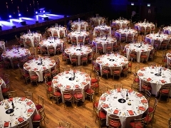 many dining tables prepared for a dinner in the main auditorium