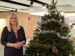 Julia standing next to Christmas tree