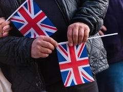 People holding Union Jack flags